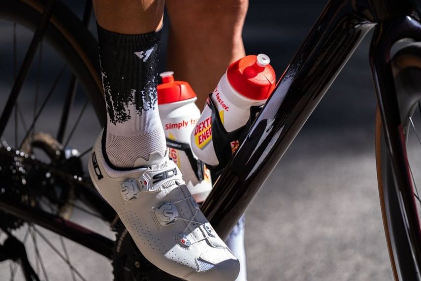 A cyclist taking an energy gel during a long road race